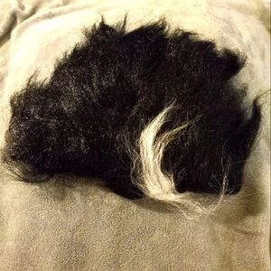 Black wig with white accents.
